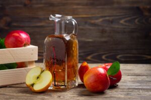 Vinaigre de cidre sur une table avec des pommes